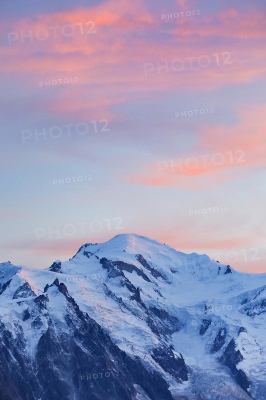 Red-coloured clouds over the summit of Mont Blanc with Aiguille du Midi in the foreground, Savoie, France, Europe