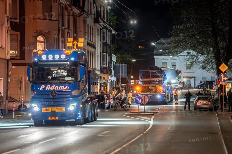 Transport of a 68 metre long, 22 tonne blade of a wind turbine, here in Schwelm, with a self-propelled Blade-Lifter vehicle, over a 40 km long route, over 2 nights, in the Bergisches Land, through towns, villages, over country roads, narrow through roads, to the construction site of the wind turbine near Hagen, North Rhine-Westphalia, Germany, Europe