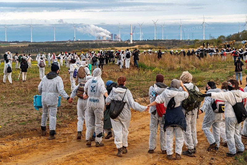 Protest action against the demolition of the village of Lützerath in the Rhenish lignite mining area, which is to make way for the expansion of the Garzweiler II open-cast mine, activists wanted to occupy an excavator, but were stopped by the police at the edge of the spoil heap, Lützerath, North Rhine-Westphalia, Germany, Europe