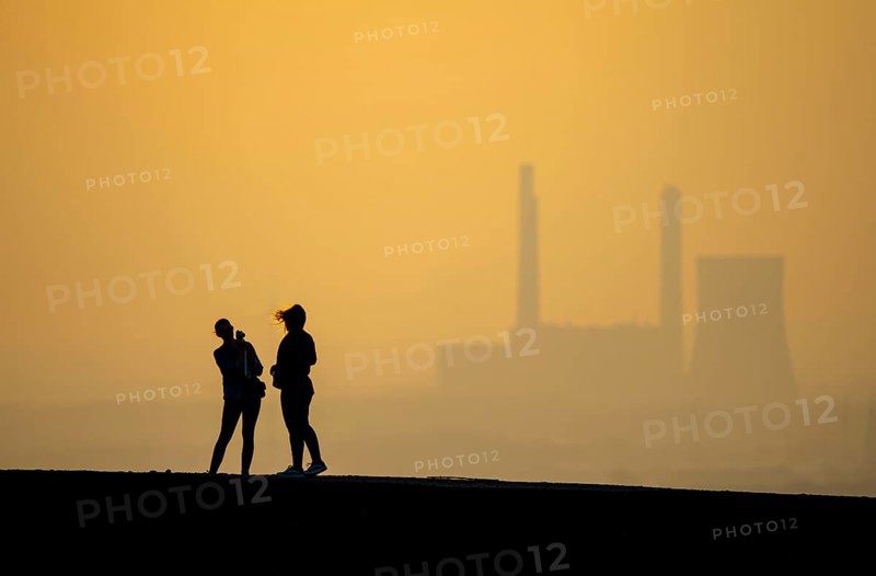 The Haniel spoil tip, 185 metres high, at the Prosper Haniel mine, closed in 2019, people on the way to the spoil tip, behind the decommissioned Voerde coal-fired power station, Bottrop, Germany, Europe