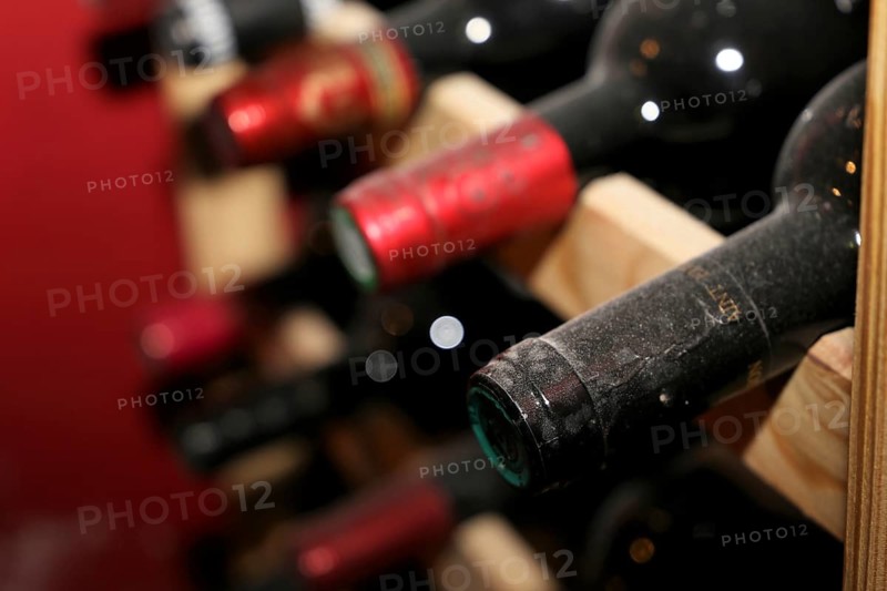 Wine cellar with red wine bottles