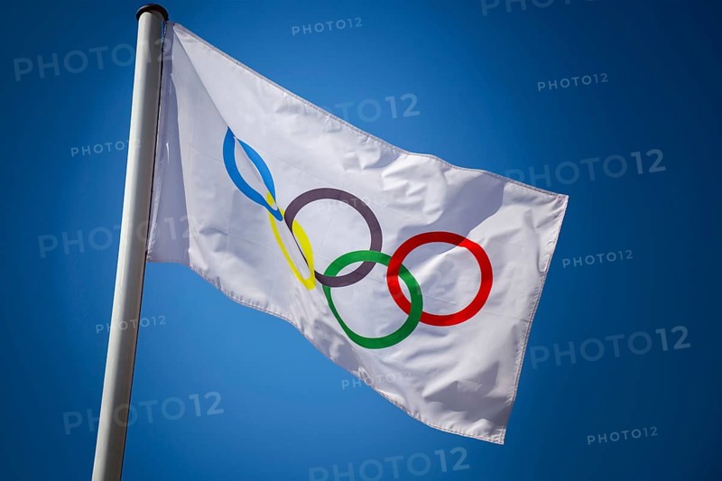 Olympic flag in front of a blue sky