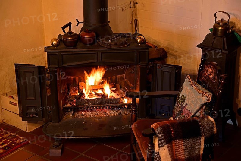 Europe, Germany, fireplace, stove, type Franklin, in living room, chair by the fireplace, Hamburg, Hamburg, Federal Republic of Germany, Europe