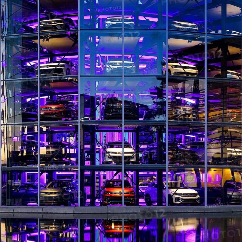 An illuminated car tower with new cars for delivery in the evening, detail, Autostadt, Volkswagen AG, Wolfsburg, Lower Saxony, Germany, Europe