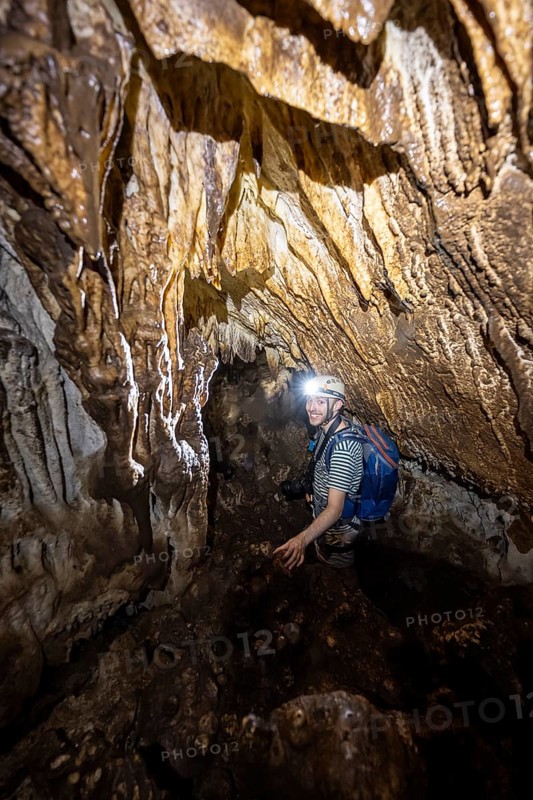 Man exploring stalactite cave, Terciopelo Cave, Barra Honda National Park, Costa Rica, Central America