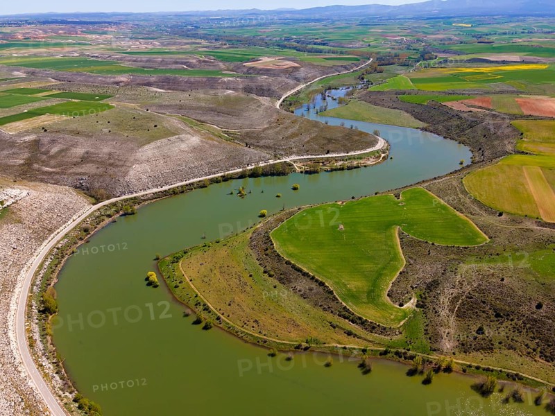 Aerial view of a river winding through a green, hilly landscape with fields, aerial view, near Maderuelo, Río Riaza, River Riaza, Segovia, Castilla y León, Leon, Spain, Europe