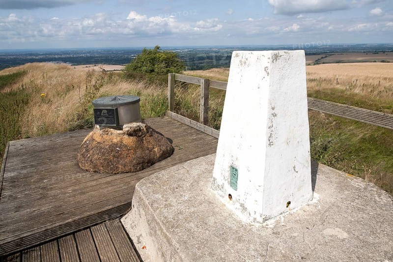 White triangulation pillar standing on a hilltop inside Liddington Castle hill fort, Wiltshire, England, United Kingdom, Europe