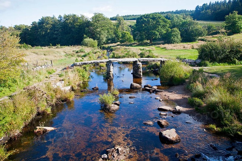 Historic medieval Clapper Bridge at Postbridge, Dartmoor national park, Devon, England crossing the East Dart river