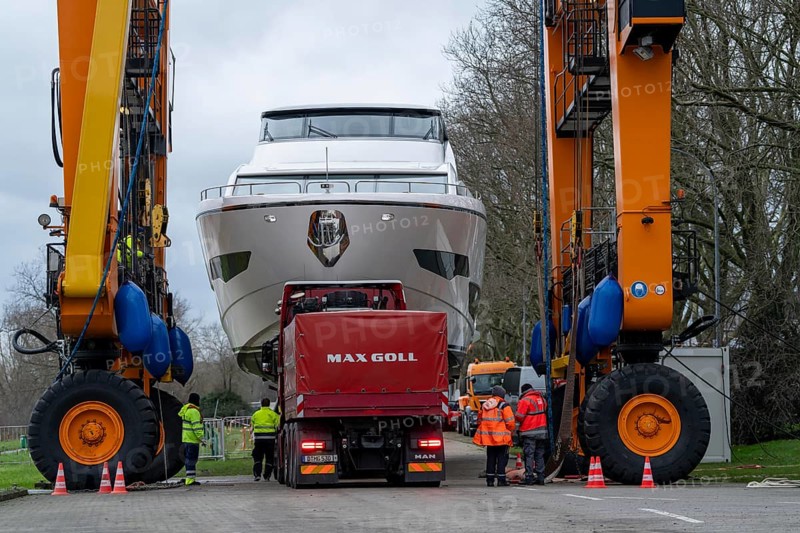 Craning the €6.3 million Sunseeker 88Y motor yacht, weighing 82 tonnes, in preparation for the world's largest water sports trade fair, Boot in Düsseldorf, luxury yachts are driven across the Rhine to the trade fair and brought ashore with the help of the Big Willi ship crane and transported to the exhibition halls on a low-loader, North Rhine-Westphalia, Germany, Europe