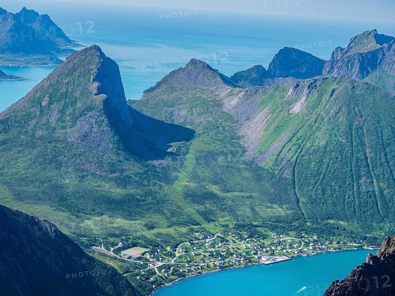 View over fjord Örnfjord to village Fjordgard, at foot of mountains Segla (left) and Hesten, seen from top of Grytetippen, island Senja, Troms, Norway, Europe