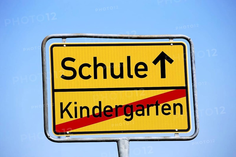 Start of school symbol: Town exit sign with the lettering Kindergarten / School