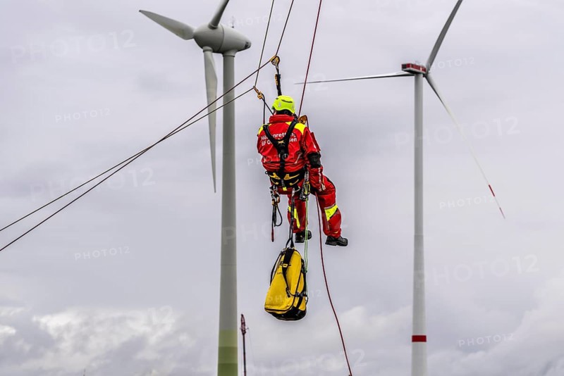 Height rescuers from the Oberhausen fire brigade practise abseiling from a wind turbine from a height of 150 metres after rescuing an accident victim from the nacelle, Issum, North Rhine-Westphalia, Germany, Europe