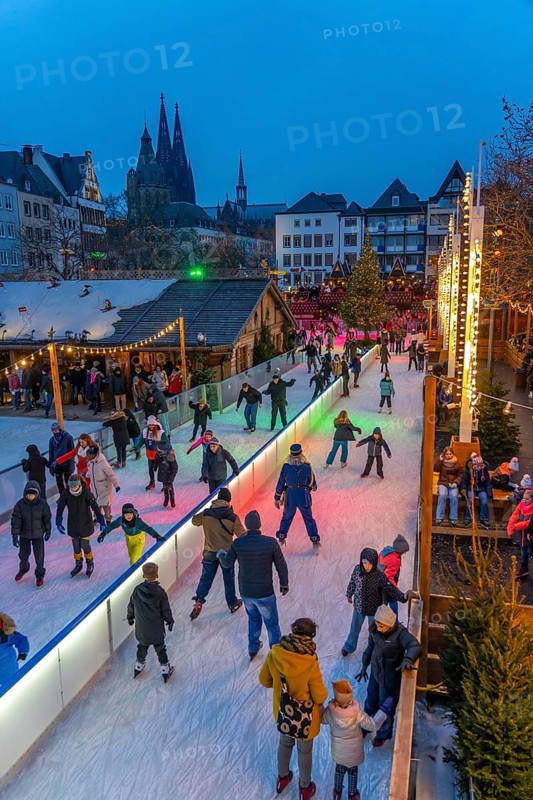 Ice rink at the Christmas market on the Heumarkt in the old town of Cologne, Cologne Cathedral, Sunday shopping in Cologne city centre, 1st Advent weekend, North Rhine-Westphalia, Germany, Europe