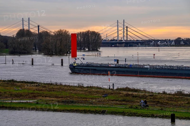 High water on the Rhine near Duisburg, freighter enters the harbour canal, Neuenkamp Rhine bridge, old and new construction, landmark Rhine orange, washed over by high water, North Rhine-Westphalia, Germany, Europe
