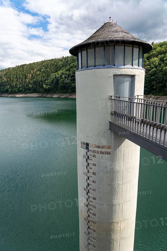The dam wall of the Urft dam, Grundablassturm, merges into the Rursee, Eifel National Park, North Rhine-Westphalia, Germany, Europe
