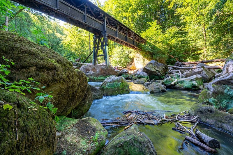 The Irrel Waterfalls, rapids in the lower reaches of the Prüm, covered wooden bridge for hikers, between Prümzurlay and Irrel, in the Eifel district of Bitburg-Prüm, Rhineland-Palatinate. Germany