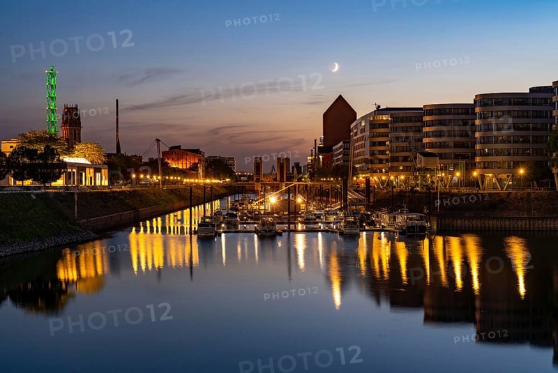 The inner harbour, Duisburg, Tower of the North Rhine-Westphalia State Archives, Stadtwerketurm, illuminated in green, North Rhine-Westphalia, Germany, Europe