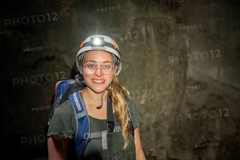 Young woman with helmet and headlamp in a stalactite cave, Terciopelo Cave, Barra Honda National Park, Costa Rica, Central America