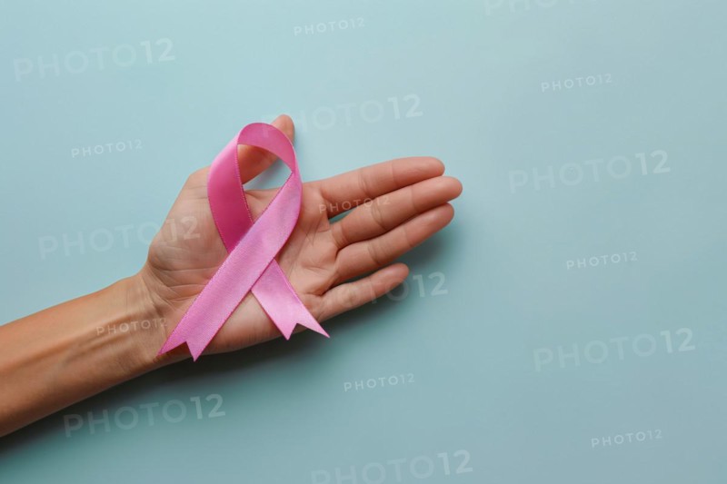 Woman's hand holding pink breast cancer awareness ribbon. KI generiert, generiert, AI generated