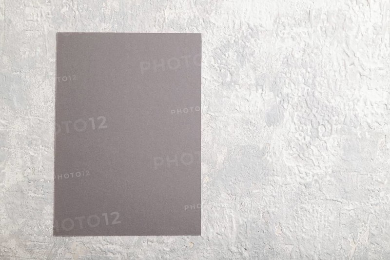Gray paper business card, mockup on gray concrete background. Blank, flat lay, top view, still life, copy space