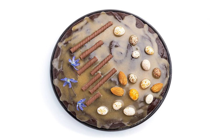 Homemade chocolate brownie cake with caramel cream and almonds isolated on a white background. top view. flat lay, close up