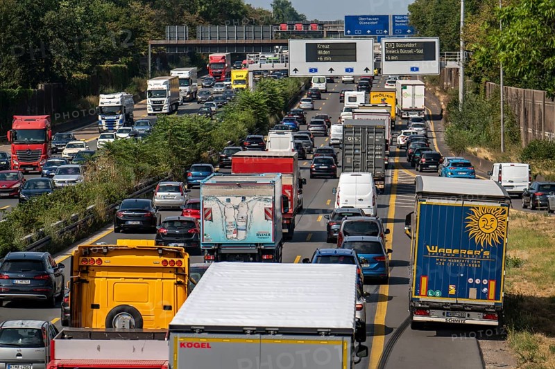 Traffic jam on the A3 motorway, over 8 lanes, in both directions, in front of the Leverkusen motorway junction, Friday afternoon high traffic volume, roadworks, gantry signs with journey times, delays due to the traffic jam, Leverkusen, North Rhine-Westphalia, Germany, Europe