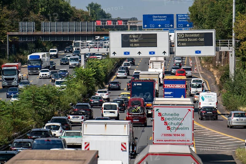 Traffic jam on the A3 motorway, over 8 lanes, in both directions, in front of the Leverkusen motorway junction, Friday afternoon high traffic volume, roadworks, gantry signs with journey times, delays due to the traffic jam, Leverkusen, North Rhine-Westphalia, Germany, Europe