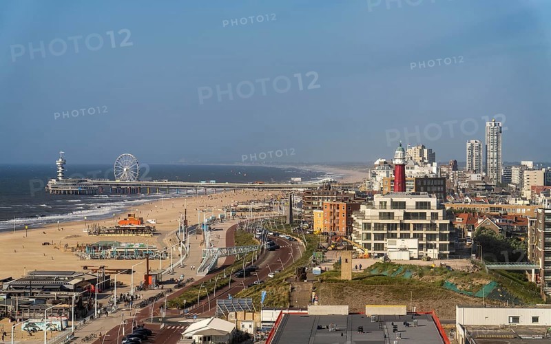 View over the beach of Scheveningen, the pier with Ferris wheel and the skyline of the town, which belongs to the city of The Hague and is the largest seaside resort in the Netherlands