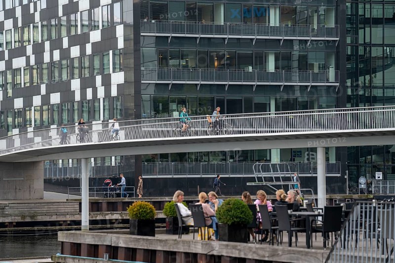 Cyclists on the Cykelslangen cycle and pedestrian bridge, at the Fisketorvet shopping centre, across the harbour, Sydhavnen, Copenhagen is considered the cycling capital of the world, 45 % of the population travel by bike, Denmark, Europe