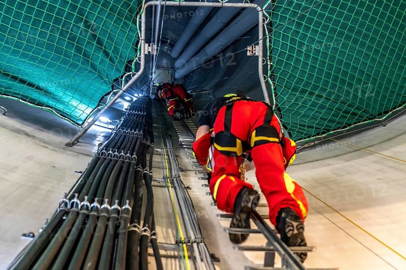 Height rescuers from the Oberhausen professional fire brigade practise abseiling from a wind turbine from a height of 150 metres, ascent into the turbine, to the nacelle, Issum, North Rhine-Westphalia, Germany, Europe