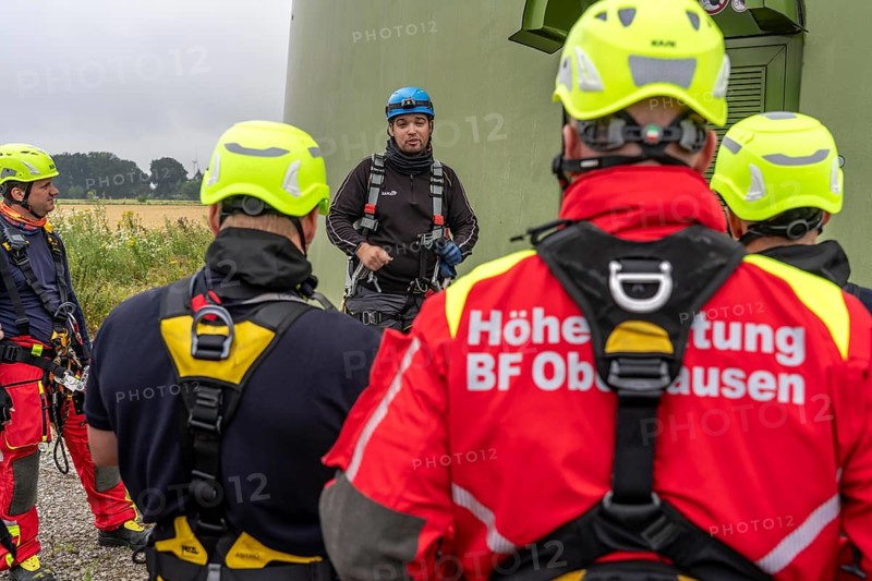 Height rescuers from the Oberhausen fire brigade practise abseiling from a wind turbine from a height of 150 metres, briefing on the turbine, in rainy weather, Issum, North Rhine-Westphalia, Germany, Europe