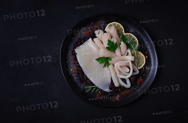 Fresh squid, raw, carcass, cut into rings, top view, no people