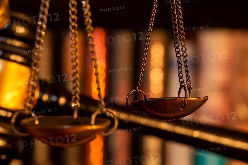 Symbolic image of justice, jurisdiction, court judgement: close-up of the scales of Justitia, a judge's gavel in the background