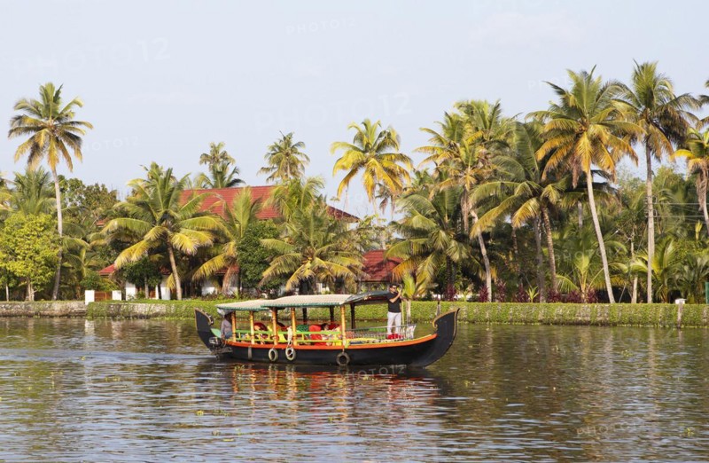Traditional shikara boat on a canal in the canal system of the backwaters, Kerala, India, Asia