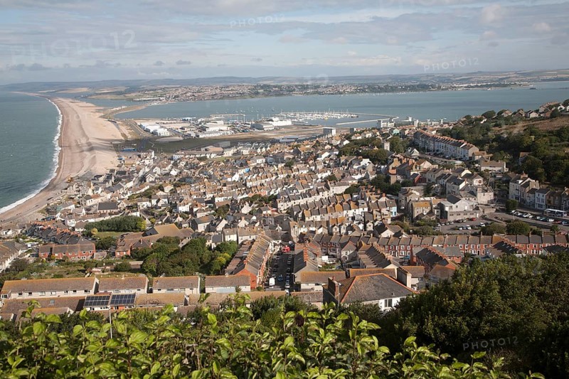 Chesil beach tombolo with high density housing in Fortuneswell, isle of Portland, Dorset, England, United Kingdom, Europe
