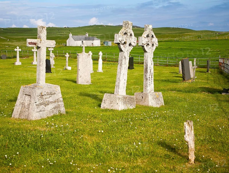 Gravestones in burial ground on Vatersay Island, Barra, Outer Hebrides, Scotland, UK, two headstones leaning towards each other