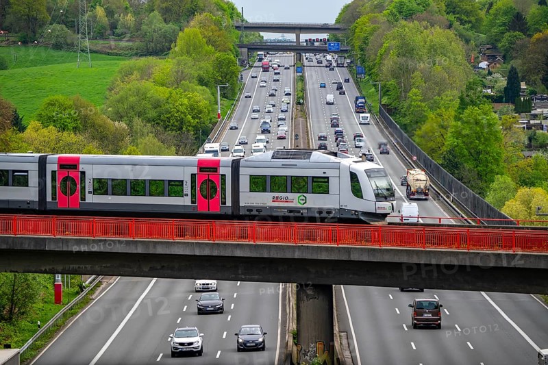 Local train S-Bahn, Regiobahn, S28, crossing the motorway A3, traffic on 8 lanes, incl. the temporarily released hard shoulder, behind the motorway junction Hilden, view in south direction, near Erkrath, North Rhine-Westphalia, Germany, Europe
