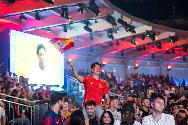Fan of the Spanish team waving a flag at the Adidas fan zone at the Bundestag during the final match between Spain and England at the European Football Championship, Berlin, 14 July 2024