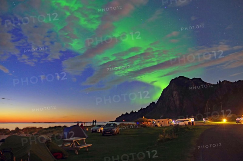 Sunset mingles with northern lights (aurora borealis), tents and caravans, Bleik, Langöya, Nordland, Norway, Europe