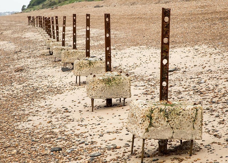 Remains of steel stanchions for barbed wire anti-invasion defences on beach at Bawdsey, Suffolk, England, UK