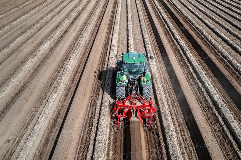 A farmer builds asparagus ridges on a field with the help of an asparagus tiller, in which the asparagus then grows, Dormagen, North Rhine-Westphalia, Germany, Europe