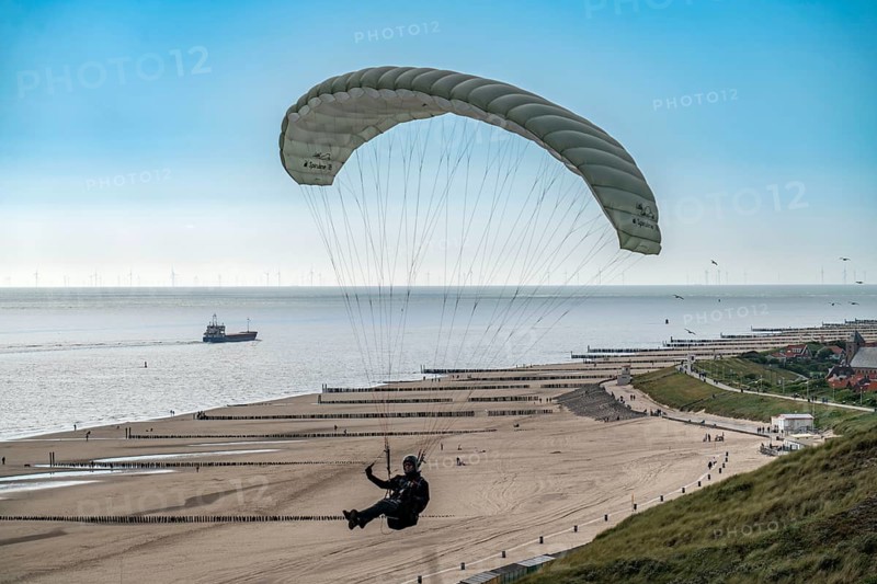 Paragliders along the dunes of Zoutelande, in Zeeland, South Holland, Netherlands