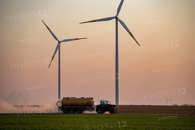 Tractor tilling a field in spring, spreading fermentation residue, residual slurry from biogas plants, on grain fields, Rhenish lignite mining area