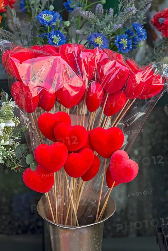Red fabric hearts at a flower stand in front of the cemetery, Genoa, Italy, Europe