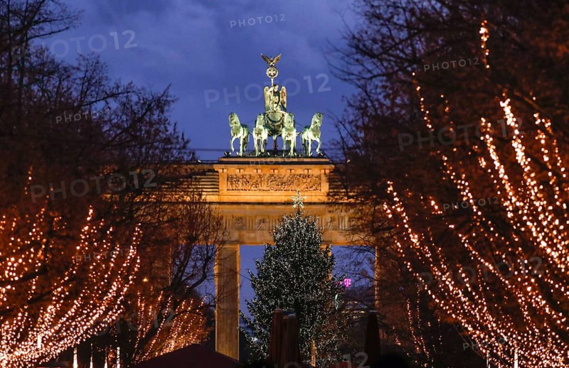 The street Unter den Linden at the Brandenburg Gate is decorated for Christmas, Berlin, 20 December 2021