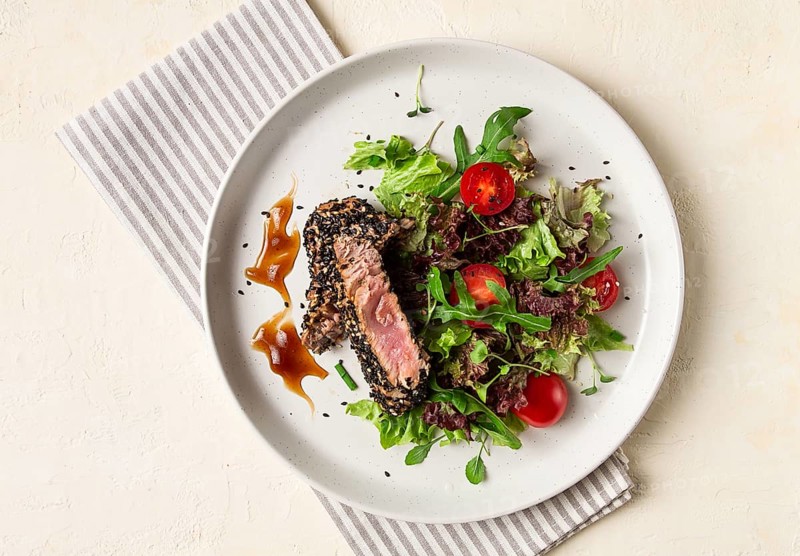 Vegetable salad, with fried tuna, in sesame seeds, healthy food, top view