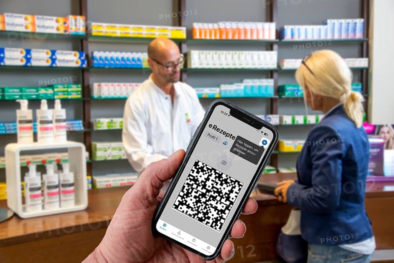 Symbolic image of an e-prescription, prescription issued by a doctor, with QR code, is scanned using a mobile phone and a special app, the code is then shown in the pharmacy and the prescription, which is stored on an IT server, can be retrieved there
