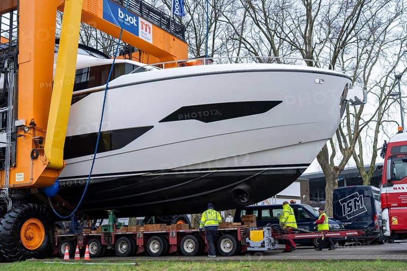 Craning the €6.3 million Sunseeker 88Y motor yacht, weighing 82 tonnes, in preparation for the world's largest water sports trade fair, Boot in Düsseldorf, luxury yachts are driven across the Rhine to the trade fair and brought ashore with the help of the Big Willi ship crane and transported to the exhibition halls on a low-loader, North Rhine-Westphalia, Germany, Europe