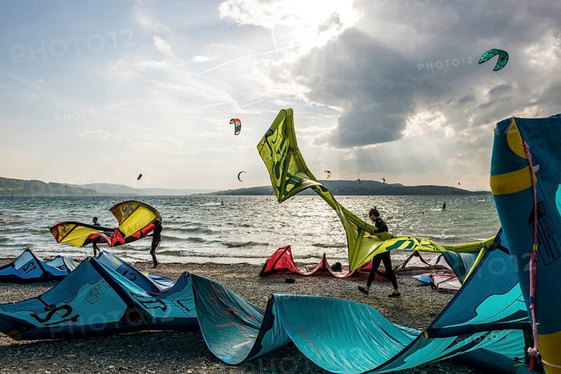 Kitesurfers and windsurfers in sun and storm, Reichenau Island, Untersee, Lake Constance, Baden-Württemberg, Germany, Europe