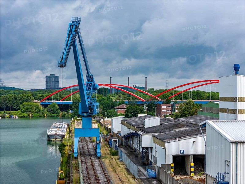 DefaultThe city harbour in the north of Essen, on the Rhine-Herne Canal, North Rhine-Westphalia, Germany, The city harbour in the north of Essen, dilapidated bridge of the A42 over the canal, ArcelorMittal's coking plant in the background, Prosper coking plant, Europe